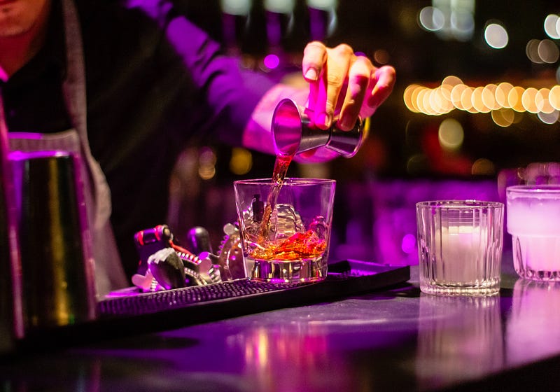 Bartender pouring a drink in a vibrant bar setting